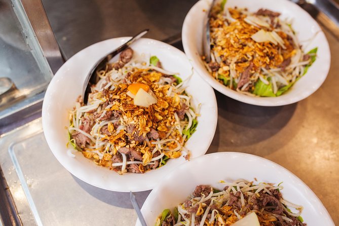 Half-Day Hanoi Food Walking Tour - Walking from the market into Hanoi’s Old Quarter