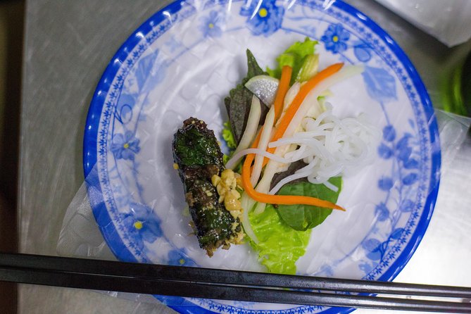 Private Street Food Evening Walking Tour in Ho Chi Minh City - Beef in betel leaf and regional noodle soup